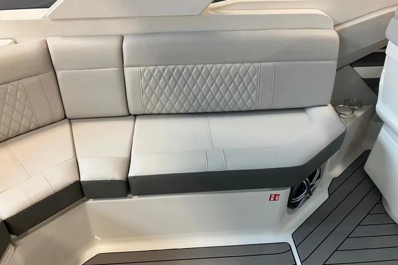Slide: The Image of Luxurious seating on 2026 Sea Ray SLX 310 Outboard with quilted upholstery and cup holders. - 9