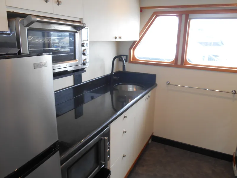 Slide: The Image of Kitchen area of a 2005 Inace Trawler with modern appliances and sleek countertops. - 10