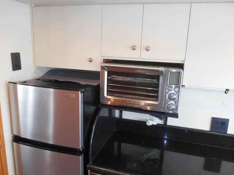 Slide: The Image of Compact kitchen area in a 2005 Inace Trawler with stainless steel appliances. - 12