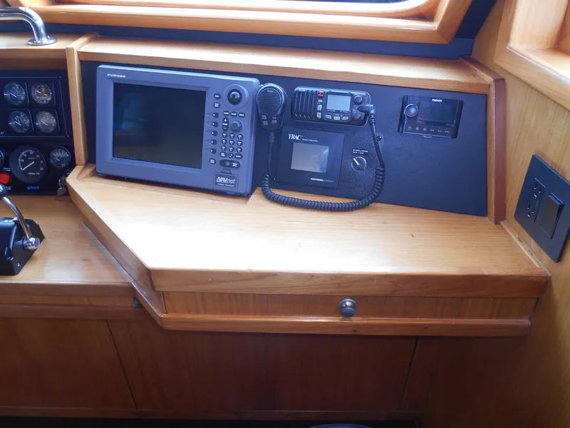 Slide: The Image of 2005 Inace Trawler navigation equipment with GPS and communication devices on wooden console. - 27