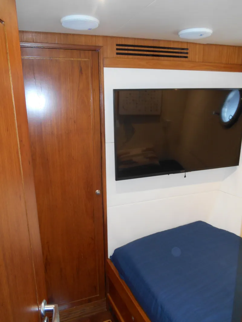 Slide: The Image of 2005 Inace Trawler cabin with wood paneling and mounted TV. - 32