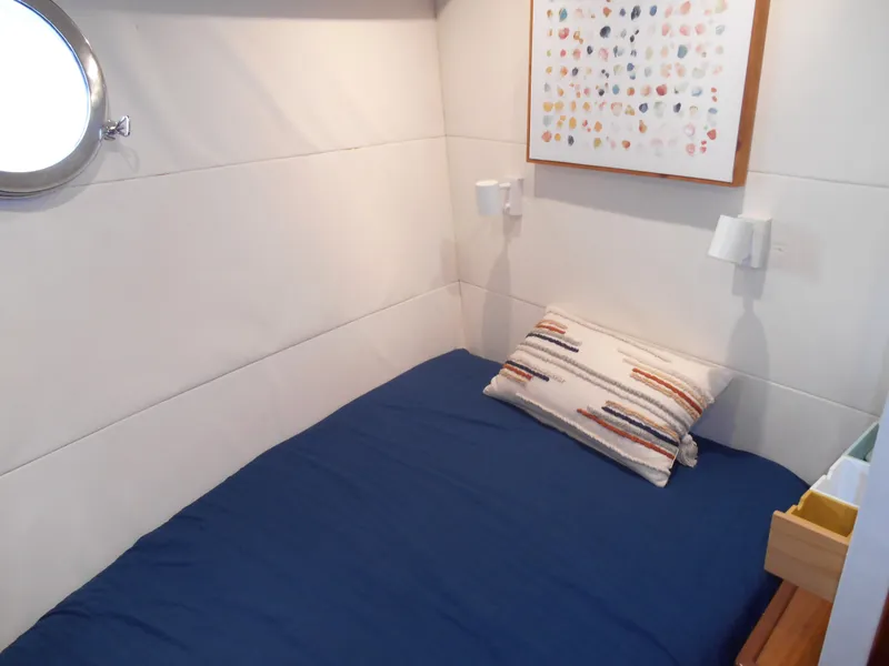 Slide: The Image of Cozy cabin bedroom in 2005 Inace Trawler with blue bedding and modern decor. - 33