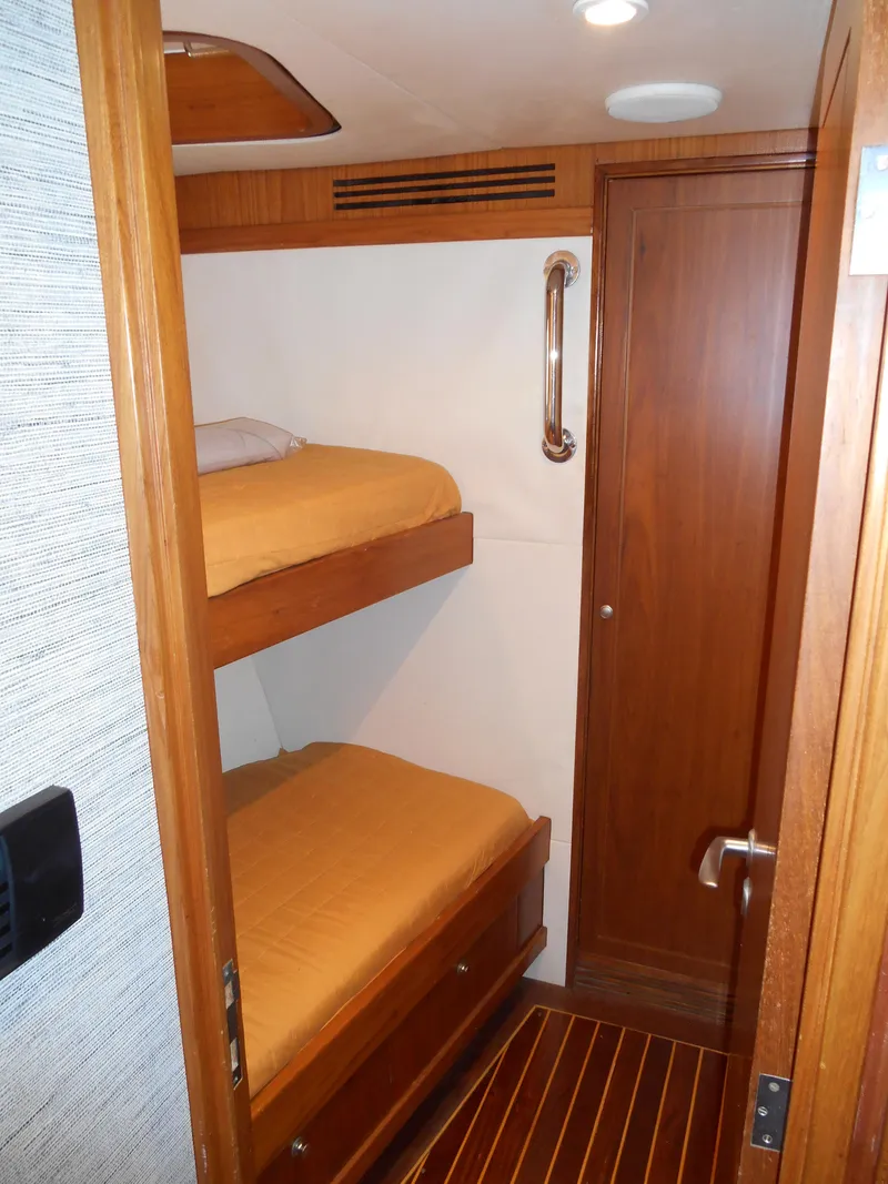 Slide: The Image of 2005 Inace Trawler cabin with wooden bunk beds and door. - 35
