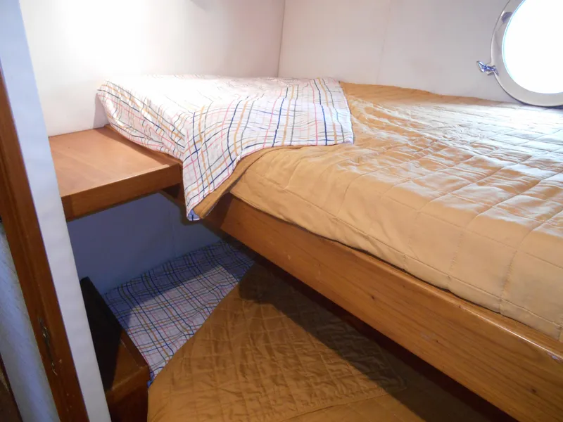 Slide: The Image of Cozy cabin interior of 2005 Inace Trawler with wooden bunk beds and porthole. - 36