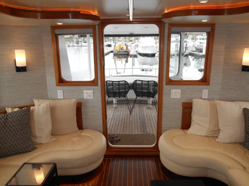 Slide: The Image of Luxurious 2005 Inace Trawler interior with plush seating and marina view. - 5