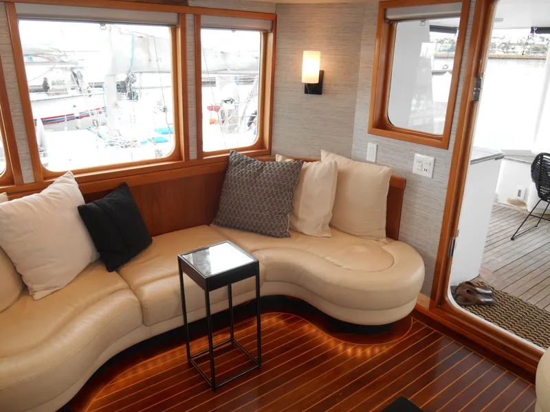 Slide: The Image of Luxurious 2005 Inace Trawler interior with curved seating, cushions, and wooden flooring. - 6