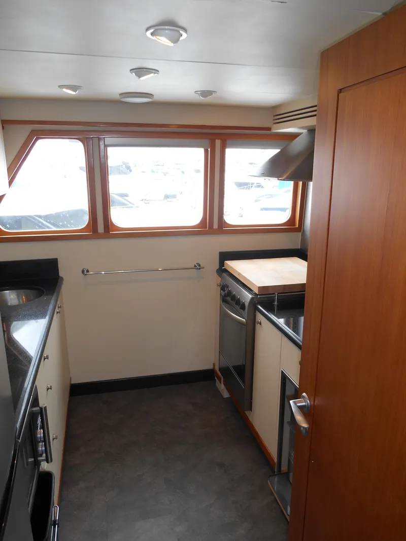 Slide: The Image of 2005 Inace Trawler kitchen interior with modern appliances and wood accents. - 9