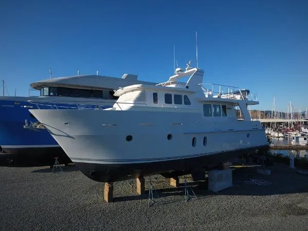 Slide: The Image of 2005 Inace Trawler yacht on dry dock, clear sky background. - 96