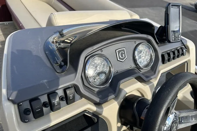 Slide: The Image of 2020 Sweetwater SW 2286 SB boat dashboard with gauges and controls. - 13