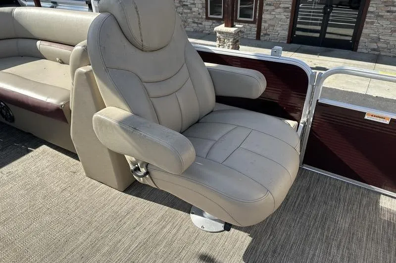 Slide: The Image of Luxurious seating on 2020 Sweetwater SW 2286 SB pontoon boat, featuring plush beige upholstery. - 14