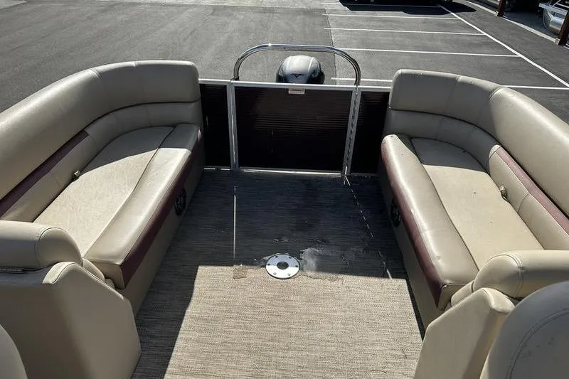 Slide: The Image of 2020 Sweetwater SW 2286 SB pontoon boat interior with beige seating and carpeted floor. - 21