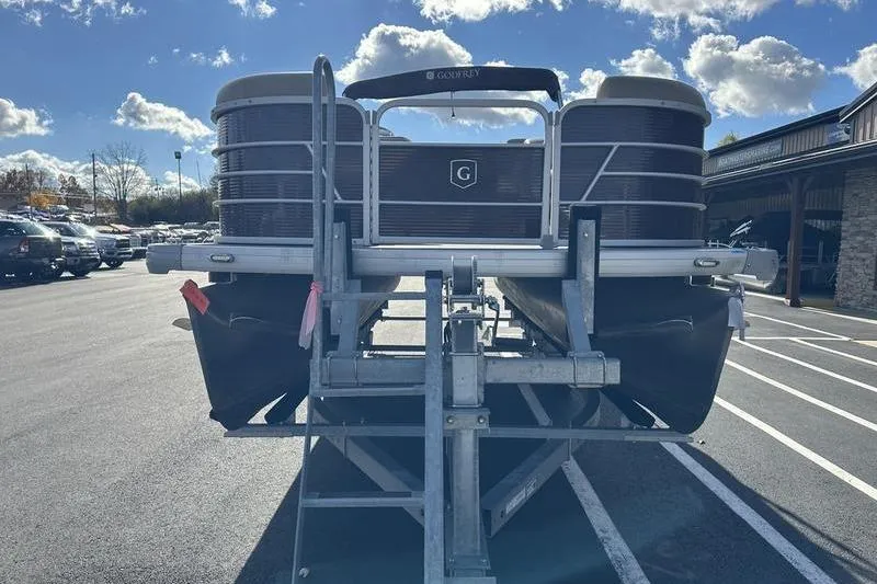 Slide: The Image of 2020 Sweetwater SW 2286 SB pontoon boat on trailer, parked under a sunny sky. - 9