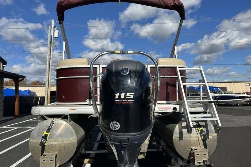 Slide: The Image of 2020 Sweetwater SW 2286 SB pontoon boat with Yamaha 115 engine, parked outdoors. - 2