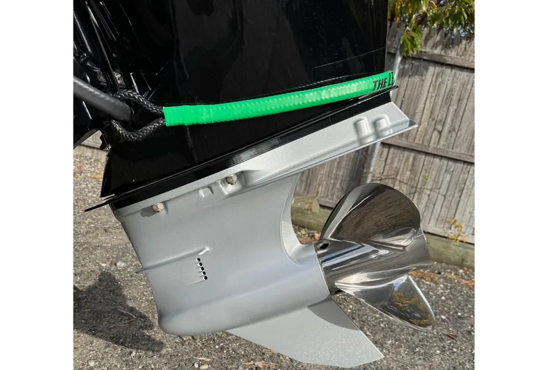 Slide: The Image of 2021 Bass Cat Cougar FTD boat motor propeller on gravel surface. - 6