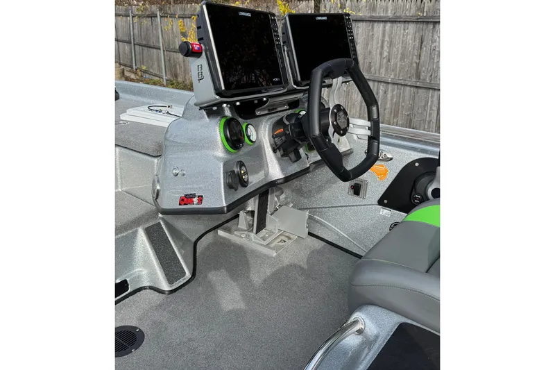 Slide: The Image of 2021 Bass Cat Cougar FTD boat dashboard with steering wheel and electronic displays. - 7