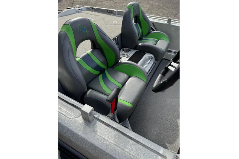 Slide: The Image of 2021 Bass Cat Cougar FTD boat interior with green and gray seats. - 8