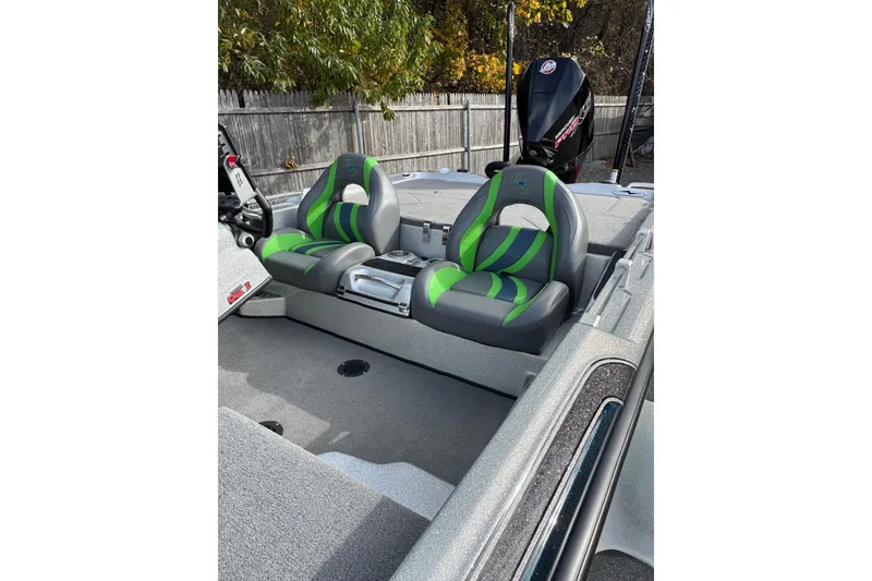 Slide: The Image of 2021 Bass Cat Cougar FTD boat interior with green and gray seats. - 9