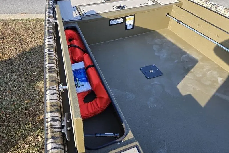 Slide: The Image of Interior of 2025 Avid 16 Commander boat with storage compartment and life jacket. - 13