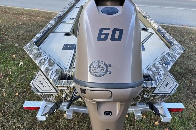 Slide: The Image of 2025 Avid 16 Commander boat with camouflage design and 60 HP outboard motor. - 3