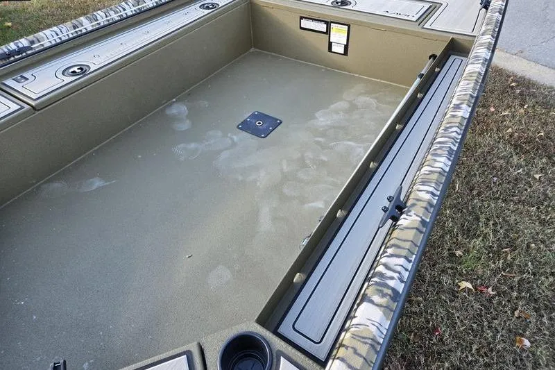 Slide: The Image of Avid 16 Commander 2025 boat interior with camouflage detailing and storage compartments. - 4