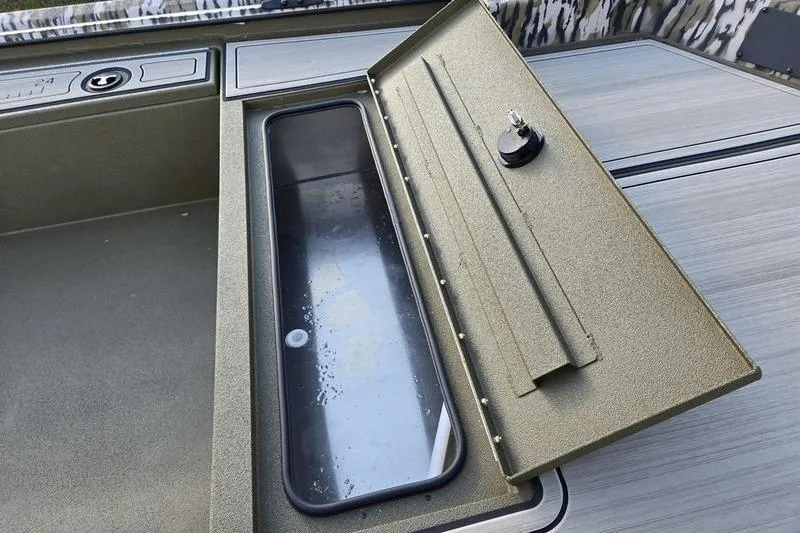 Slide: The Image of Open storage compartment on 2025 Avid 16 Commander boat, showcasing interior details. - 5