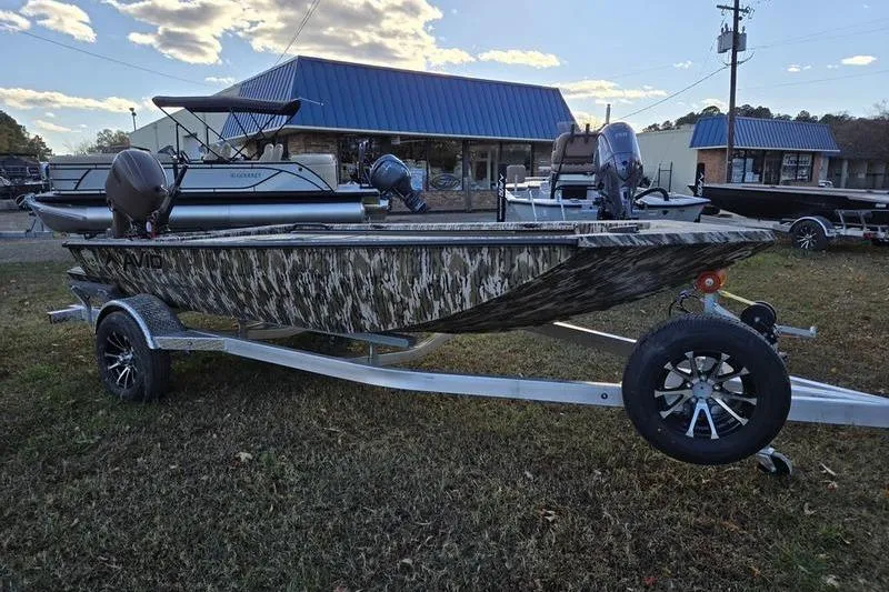 Slide: The Image of Avid 16 Commander 2025 boat with camouflage design on a trailer, outdoors. - 7