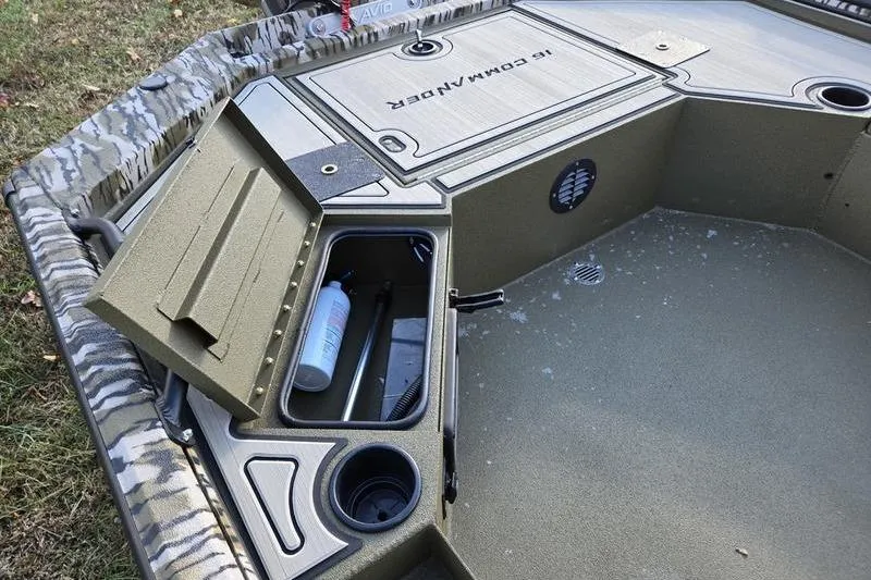 Slide: The Image of 2025 Avid 16 Commander boat interior with storage compartment and cup holder. - 8