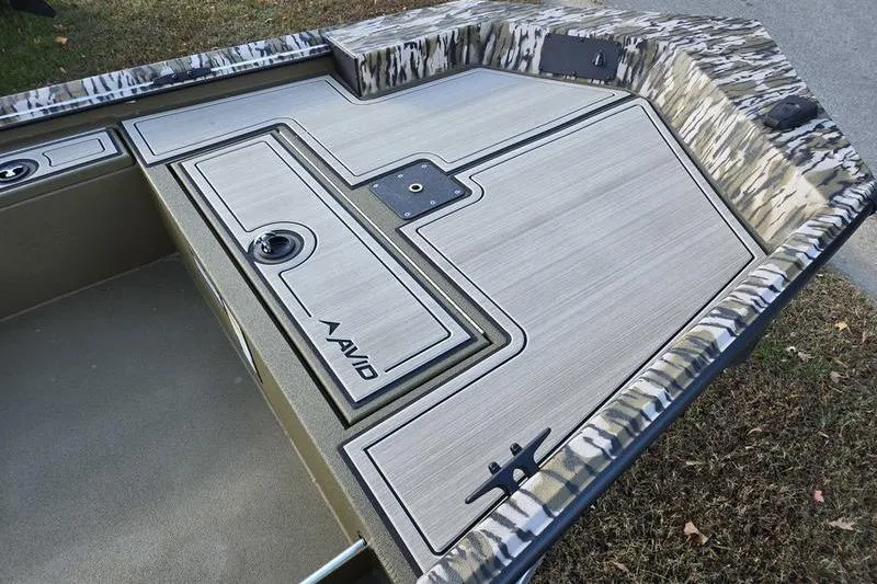 Slide: The Image of Avid 16 Commander 2025 boat deck with camouflage pattern and storage compartments. - 9