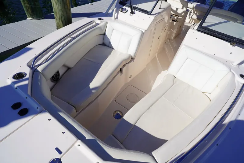 Slide: The Image of 2015 Grady-White Freedom 307 boat interior with white cushioned seating. - 11