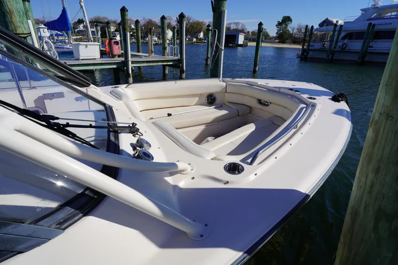 Slide: The Image of 2015 Grady-White Freedom 307 boat docked, featuring spacious seating and sleek design. - 12