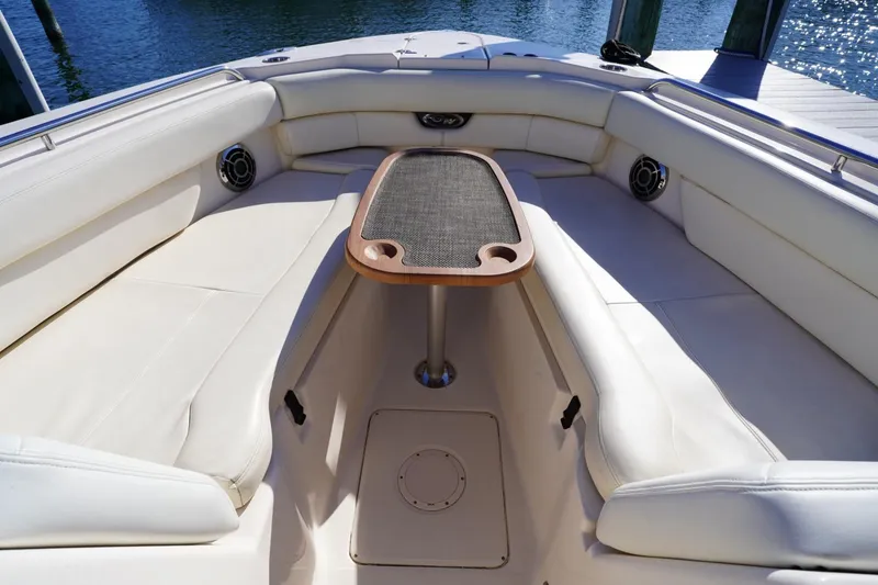 Slide: The Image of Luxurious seating area on 2015 Grady-White Freedom 307 boat with table. - 15