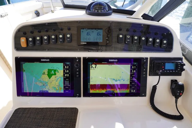 Slide: The Image of Control panel of 2015 Grady-White Freedom 307 boat with navigation and communication systems. - 16
