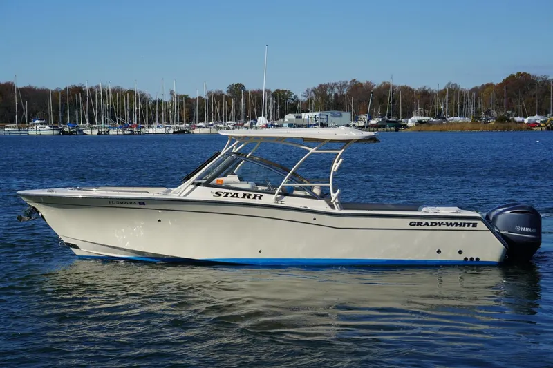 Slide: The Image of 2015 Grady-White Freedom 307 boat on calm lake waters. - 2