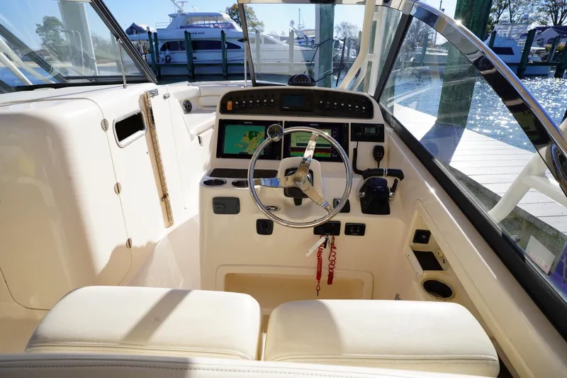 Slide: The Image of 2015 Grady-White Freedom 307 boat cockpit with steering wheel and navigation system. - 21