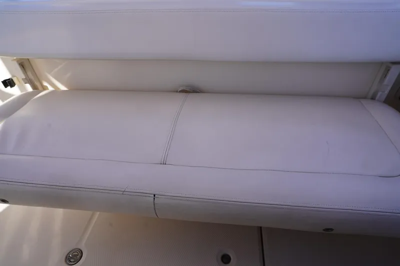 Slide: The Image of 2015 Grady-White Freedom 307 boat seat, white upholstery, close-up view. - 31