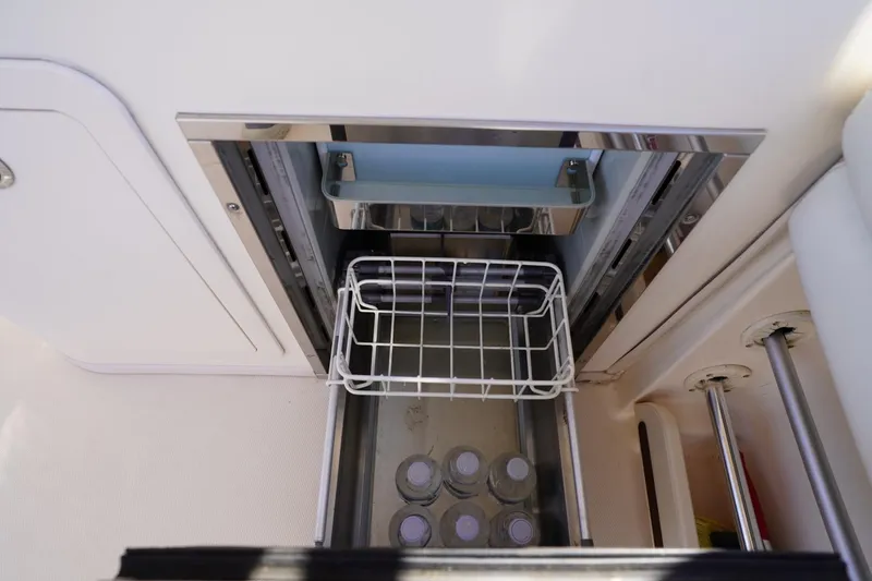 Slide: The Image of Built-in cooler on 2015 Grady-White Freedom 307 boat with water bottles inside. - 32