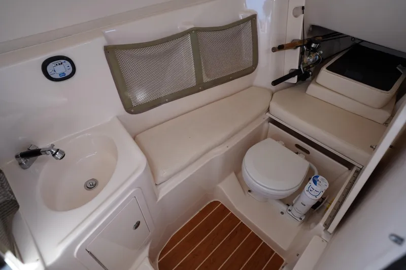 Slide: The Image of 2015 Grady-White Freedom 307 boat interior with sink, toilet, and seating area. - 35