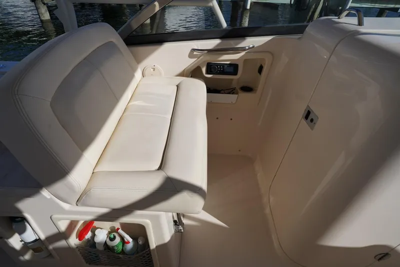 Slide: The Image of 2015 Grady-White Freedom 307 boat interior with beige seating and storage compartments. - 36
