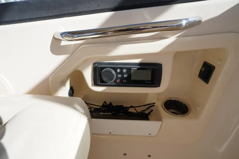 Slide: The Image of 2015 Grady-White Freedom 307 boat interior with Fusion stereo system and cup holder. - 37