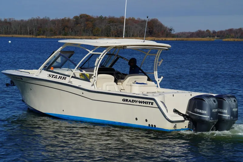 Slide: The Image of 2015 Grady-White Freedom 307 boat with dual Yamaha engines on the water. - 4