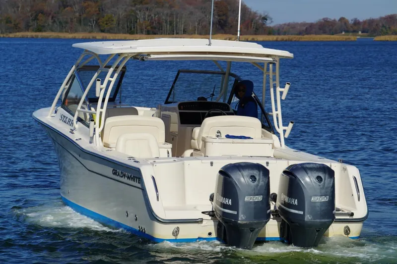 Slide: The Image of 2015 Grady-White Freedom 307 boat on water with Yamaha engines. - 5