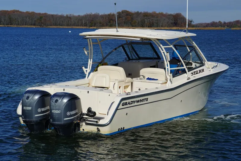 Slide: The Image of 2015 Grady-White Freedom 307 boat on water with twin Yamaha engines. - 8