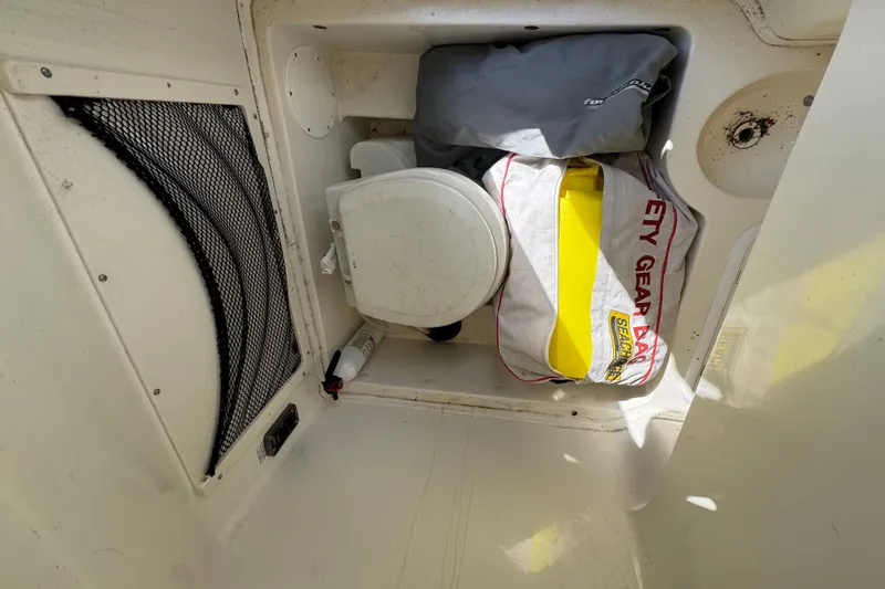 Slide: The Image of Storage compartment of 2018 NauticStar 2602 Legacy boat with safety gear and equipment. - 13