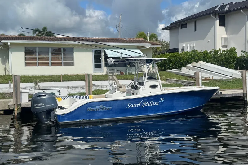 Slide: The Image of 2018 NauticStar 2602 Legacy boat docked, featuring Yamaha engine, named "Sweet Milissa." - 2