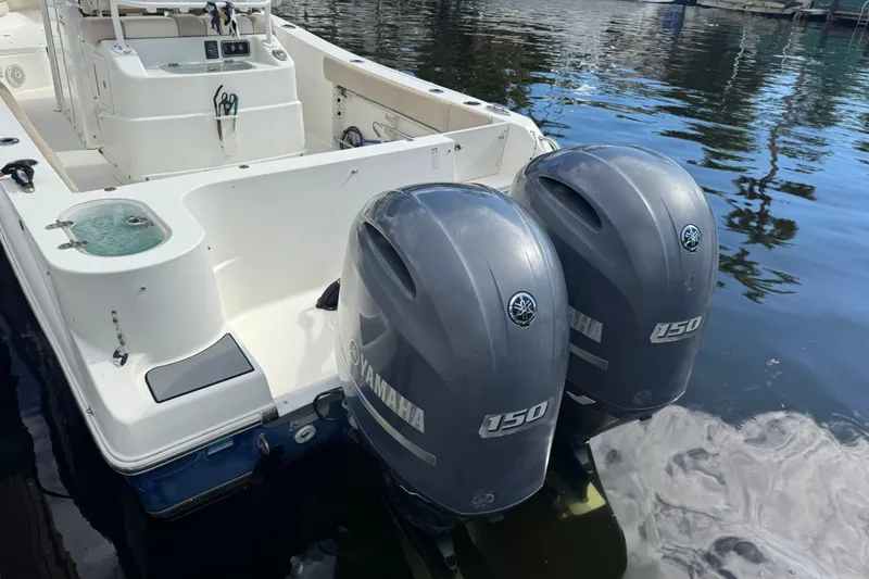 Slide: The Image of 2018 NauticStar 2602 Legacy boat with twin Yamaha 150 engines on water. - 5