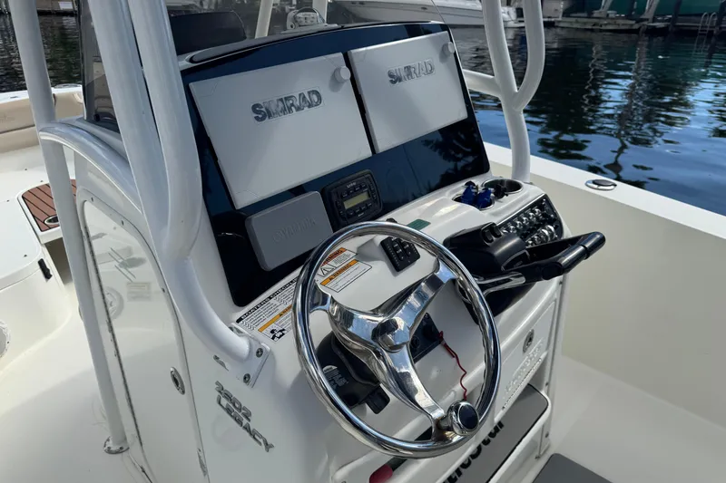 Slide: The Image of 2018 NauticStar 2602 Legacy boat console with steering wheel and Simrad electronics. - 6