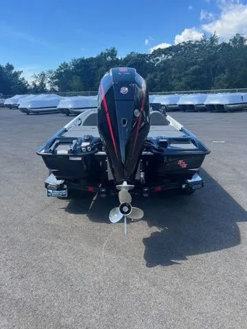 Slide: The Image of 2026 Bass Cat Pantera Classic boat, rear view, parked outdoors under a clear sky. - 2