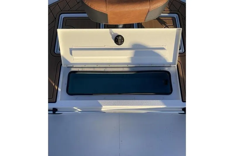 Slide: The Image of Open storage compartment on 2026 Avid 18 Rogue CC boat deck. - 4