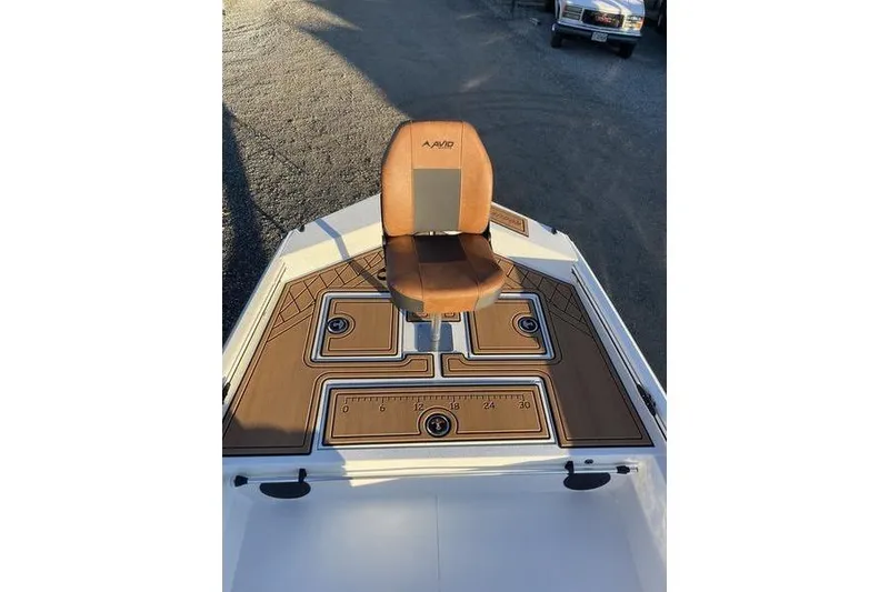Slide: The Image of 2026 Avid 18 Rogue CC boat with brown seat and deck, featuring storage compartments. - 5