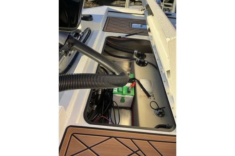 Slide: The Image of Open compartment of 2026 Avid 18 Rogue CC boat showing internal components and wiring. - 9